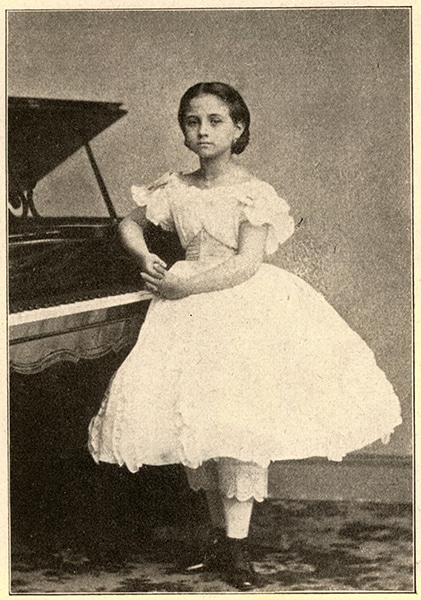 TERESA CARREÑO, AGE 8, AT THE PIANO.