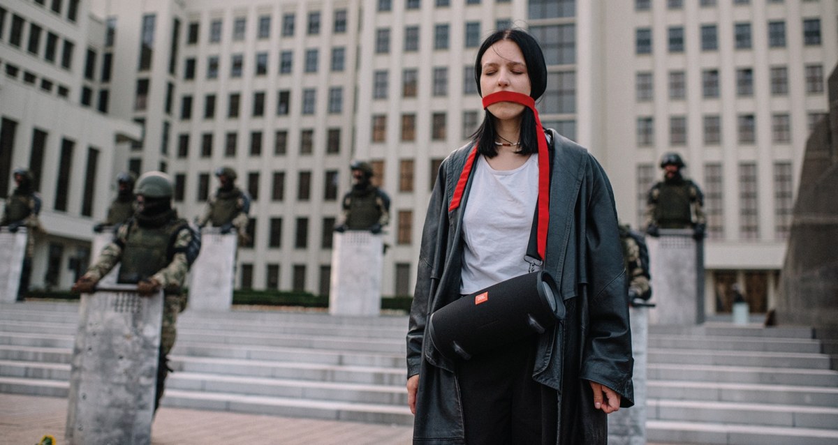 Protester in Minsk, Belarus with a red sash tied around her mouth